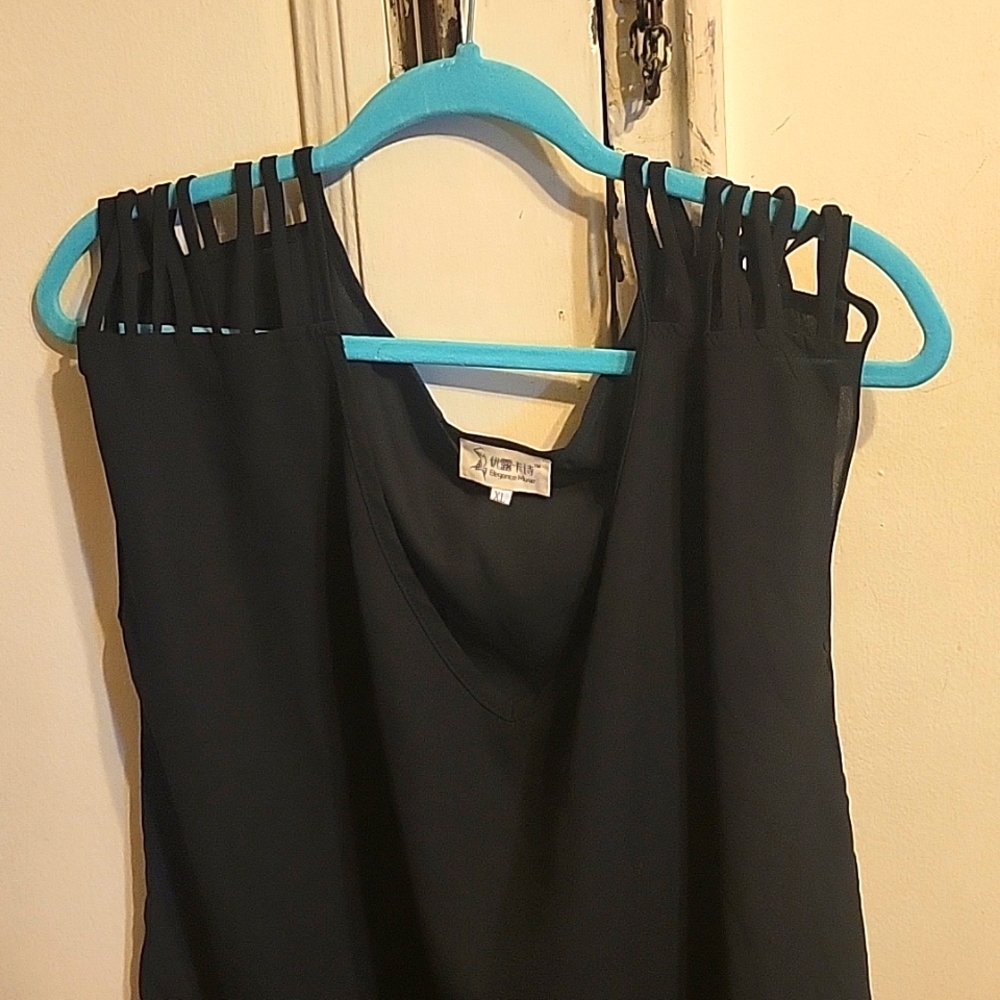 Black top with shoulder fringe.